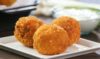Crispy potato balls with a golden exterior, cooked to perfection using olive oil.