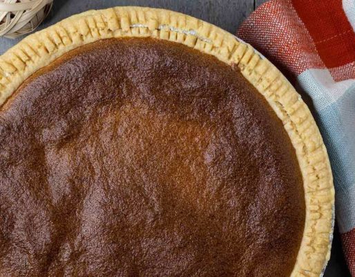 Scrumptious brown pie with a golden crust, filled with a rich and flavorful combination of ingredients.
